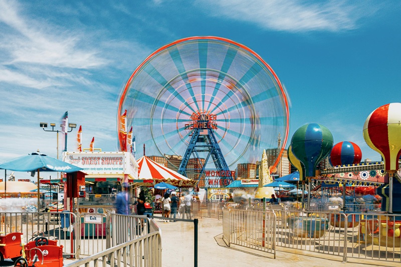Visitors enjoying rides at an Orlando theme park with discount tickets in 2025