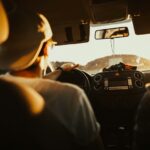 Driver navigating a car during a road trip at sunset in Florida