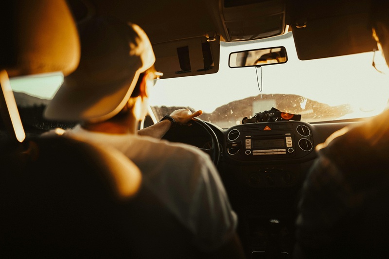 Driver navigating a car during a road trip at sunset in Florida