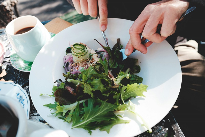 Fresh vegan salad served at a vegetarian-friendly restaurant in Orlando with greens, cucumbers, and sesame toppings.
